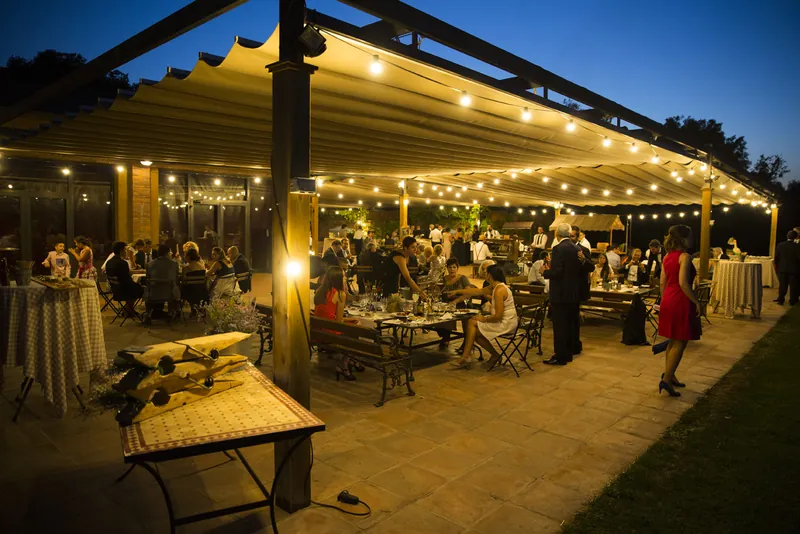 Banquete en una terraza iluminada con guirnaldas de luces